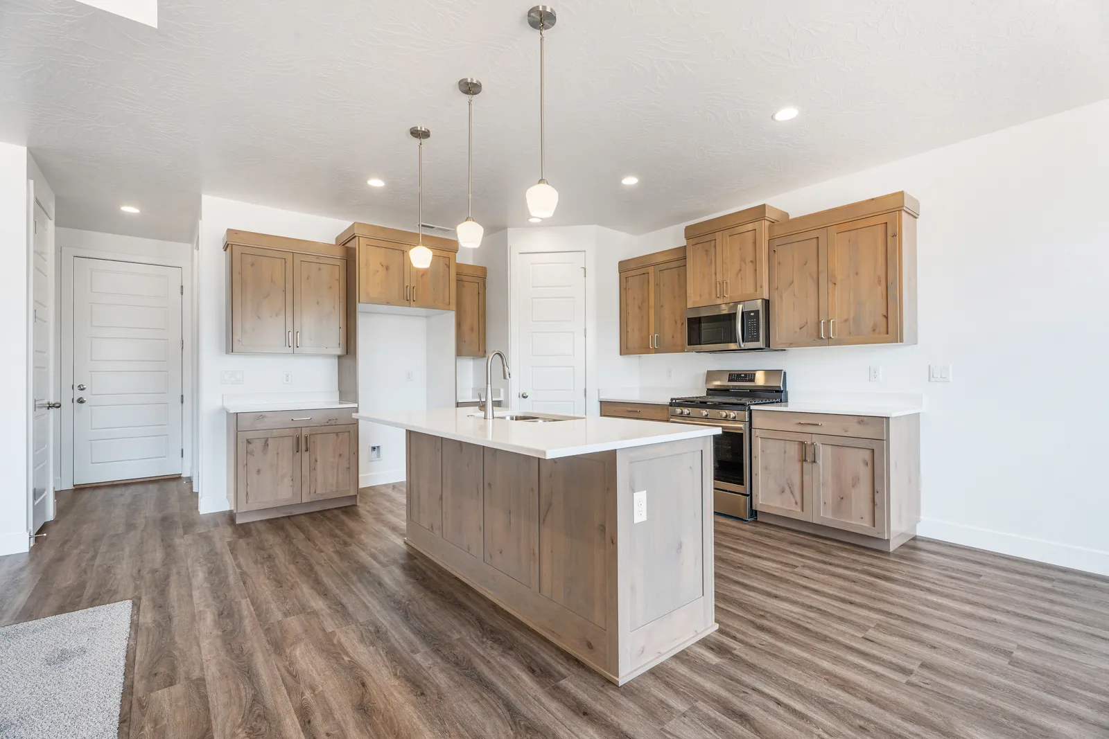 Kitchen with light wood cabinets and a white island