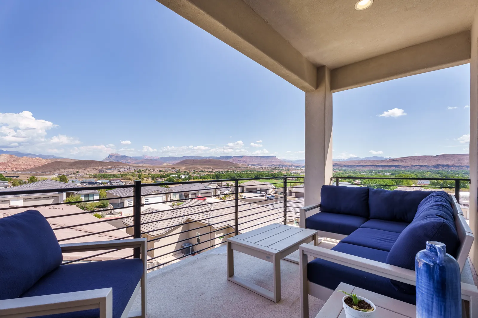 Covered upper deck with outdoor sofas looking over the valley