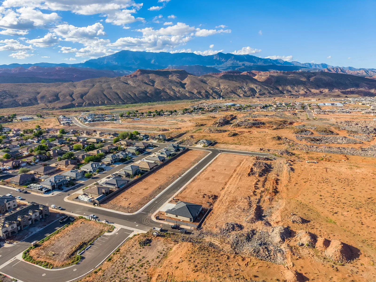 Aerial view of Lava Knolls, with finished homes, new streets and open lots below the mountains
