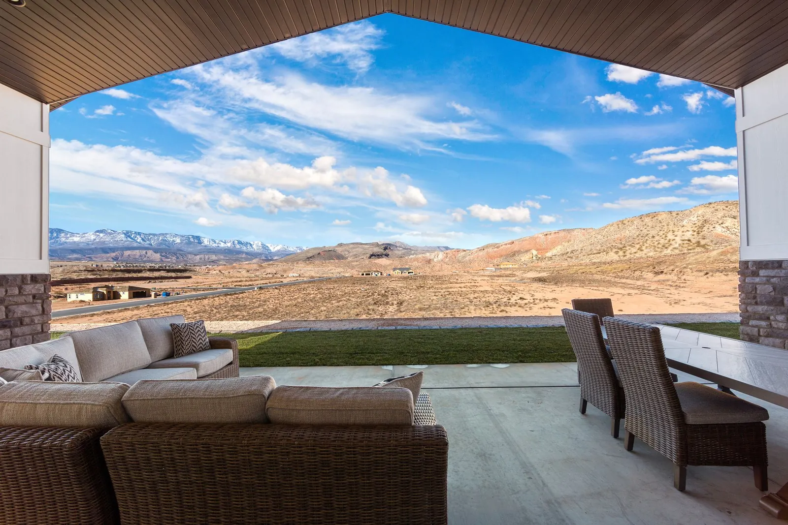 Covered patio with outdoor seating and a desert view